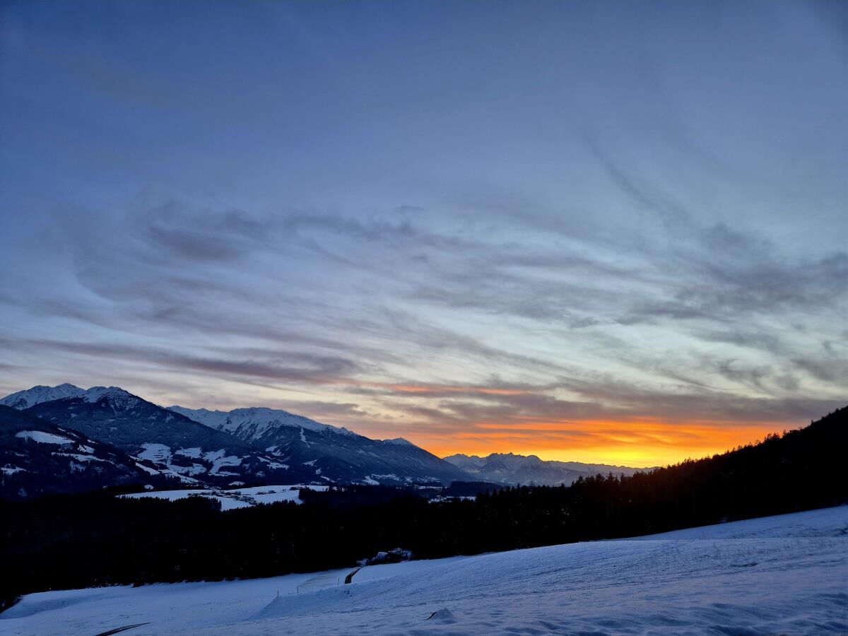 Evening glow over the snow-covered mountain landscape near the Karwendel, a winter evening at the secluded Tiroler Hütte