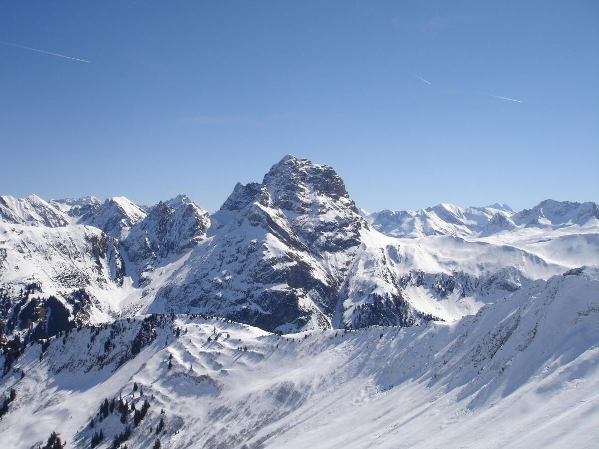 Aerial view of the snow-covered rocky peaks of the Allgäu and Walser Alps above the Kleinwalsertal, the mountain world of the Bergwiese luxury lodge Zwölferkopf