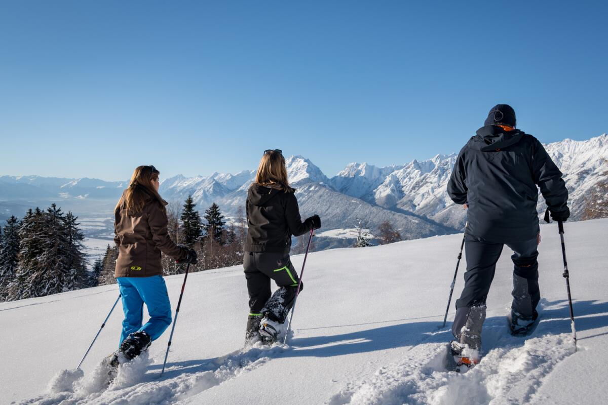 Snowshoe walkers above the Inn valley near the Grafenhäusl, winter walking in the Karwendel nature park