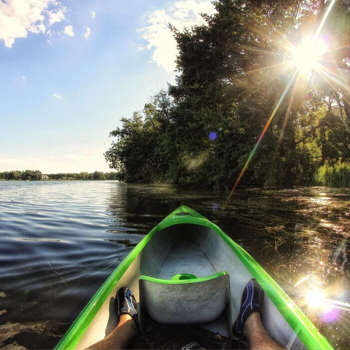 Streife am großen See mit dem Kanu alleine entlang des Ufers.
