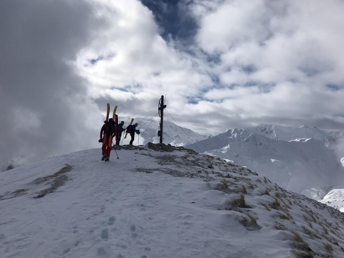 Ski tour reaching the summit near the Breitbergalm, winter sport straight from the mountain cabin in the Zillertal