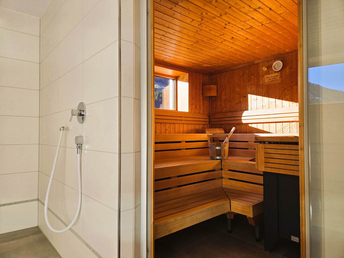 Tiled shower right in front of the sauna cabin of the Walser Lodge, wellness area for guests of the Panorama luxury lodge Ifen