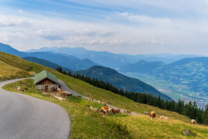 Zillertaler Höhenstraße with an Alm hut on the slope and a view down into the Zillertal