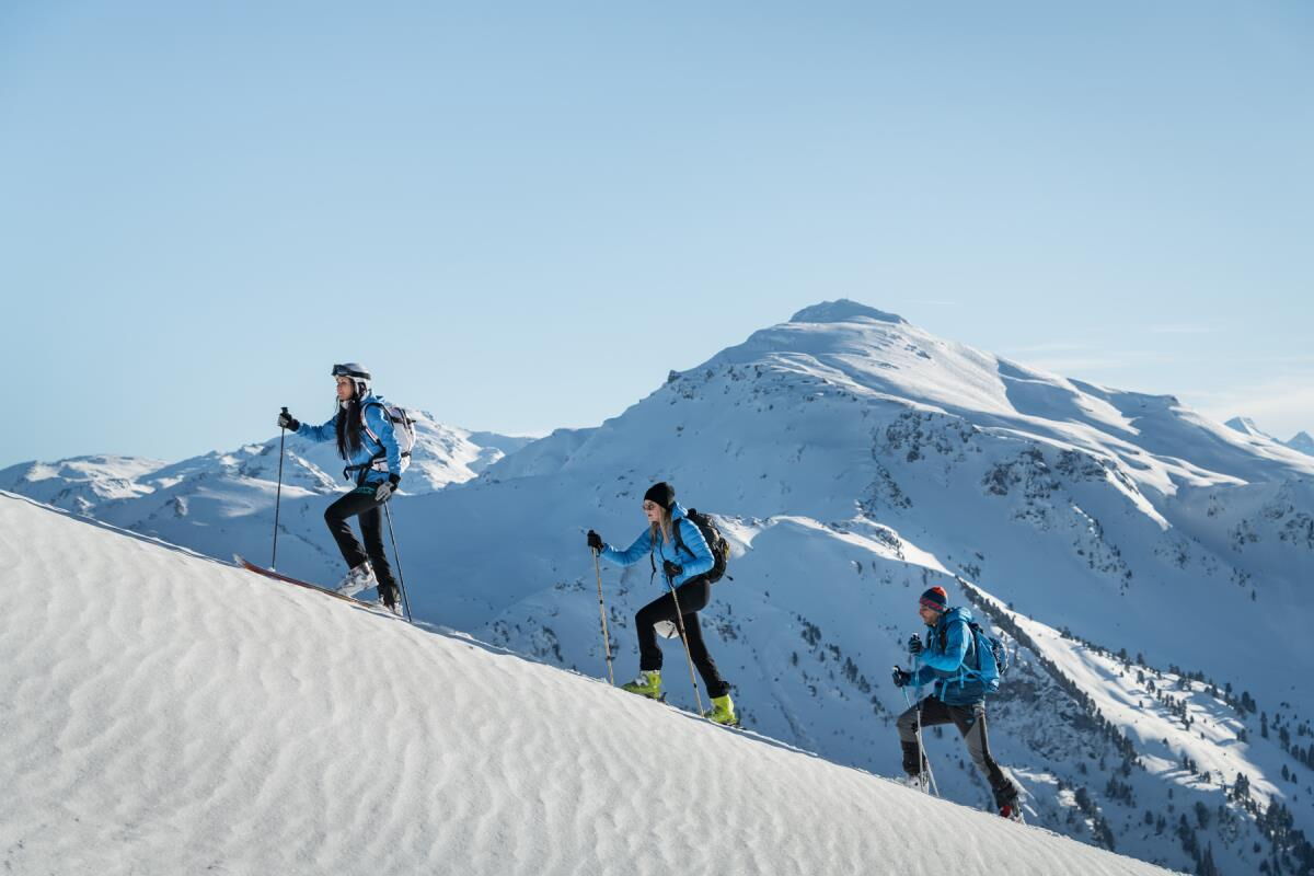 Drei Skitourengeher im Aufstieg am verschneiten Grat in den Tuxer Alpen, Skitouren ab der Ferienwohnung Sternenhimmel am Kolsassberg