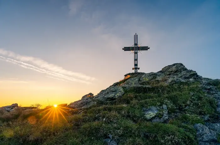 Summit cross in the Tux foothills above the Zillertal in evening light
