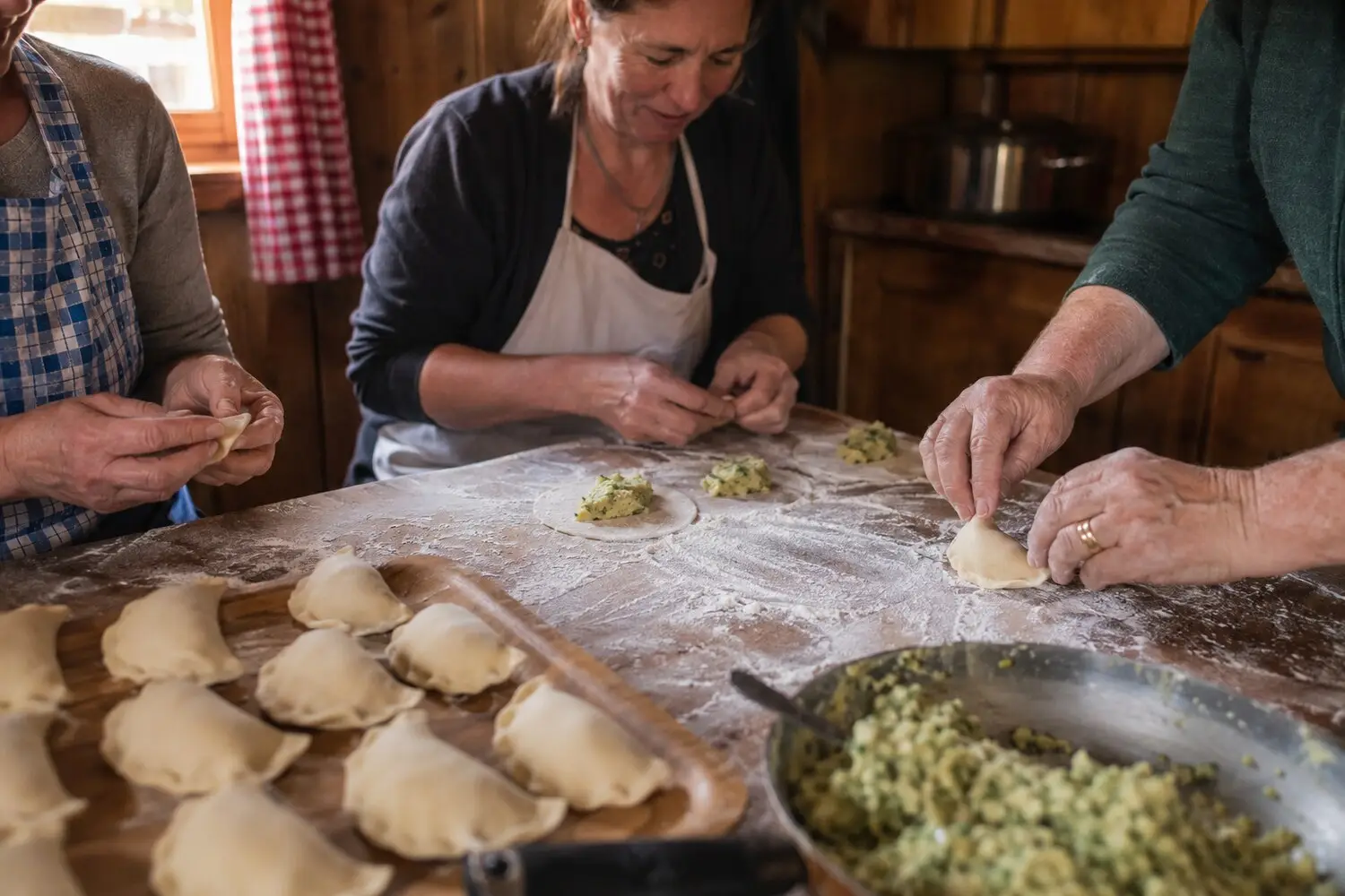 Osttiroler Schlipfkrapfen being prepared and enjoyed at the hut